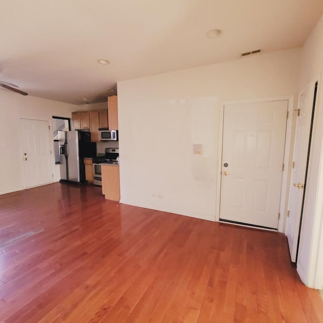 unfurnished living room featuring recessed lighting, visible vents, and dark wood-style flooring