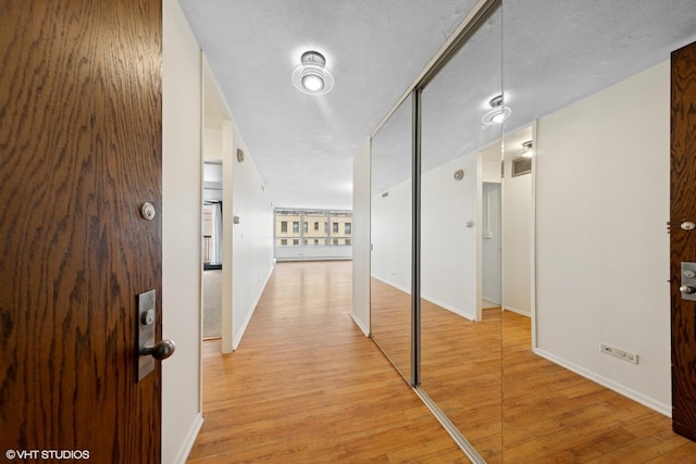 201 E Chestnut St Unit 14E, Chicago, IL 60611 - corridor featuring light wood-style floors and baseboards