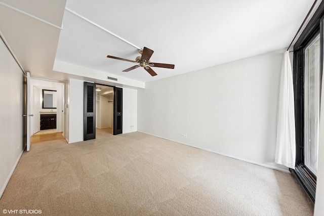 201 E Chestnut St Unit 14E, Chicago, IL 60611 - unfurnished bedroom featuring light carpet, a walk in closet, baseboards, a closet, and multiple windows