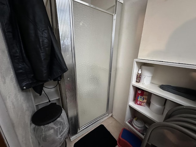 full bathroom with tile patterned floors and a stall shower