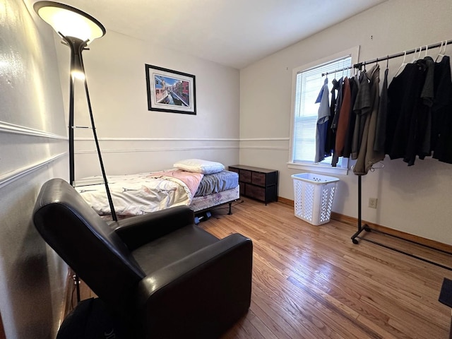 bedroom featuring baseboards and wood finished floors