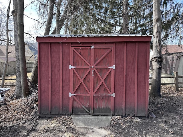 view of shed featuring fence