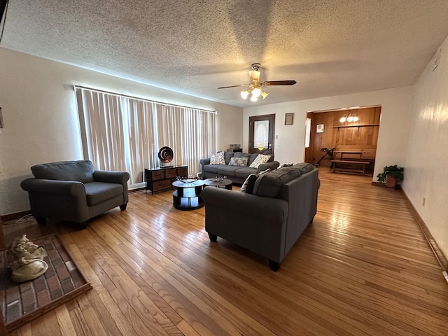 living area featuring a textured ceiling, a ceiling fan, and hardwood / wood-style floors