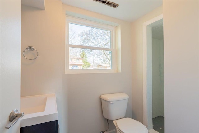 full bath featuring vanity, toilet, and visible vents