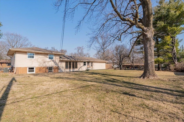 back of property with cooling unit and a lawn