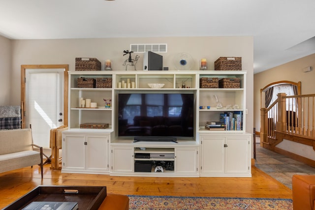 4201 Brittany Trail Dr, Champaign, IL 61822 - living area featuring visible vents, light wood-style flooring, and stairway