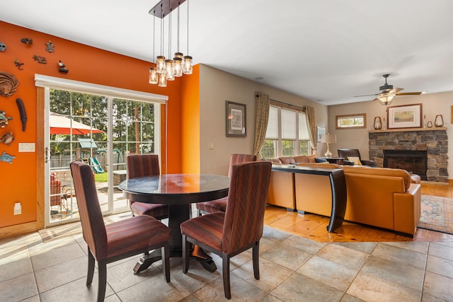 4201 Brittany Trail Dr, Champaign, IL 61822 - dining space featuring ceiling fan with notable chandelier and a stone fireplace