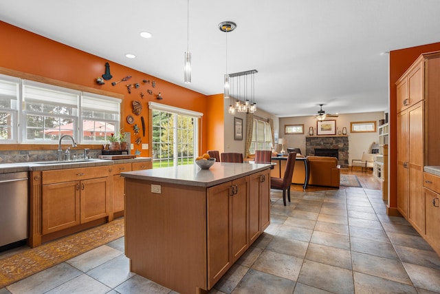 4201 Brittany Trail Dr, Champaign, IL 61822 - kitchen featuring a kitchen island, a stone fireplace, ceiling fan, a sink, and dishwasher