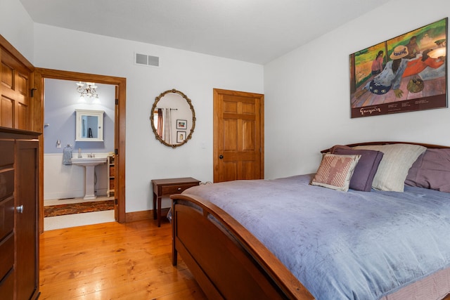 4201 Brittany Trail Dr, Champaign, IL 61822 - bedroom with visible vents, baseboards, connected bathroom, a sink, and light wood-style flooring