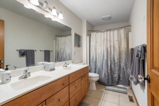 4201 Brittany Trail Dr, Champaign, IL 61822 - bathroom with toilet, visible vents, a sink, and tile patterned flooring