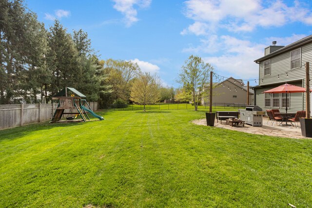 4201 Brittany Trail Dr, Champaign, IL 61822 - view of yard with a fenced backyard, a patio, and a playground