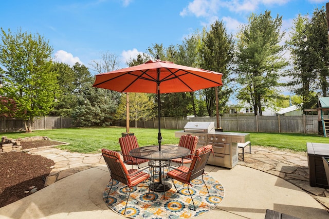 4201 Brittany Trail Dr, Champaign, IL 61822 - view of patio with outdoor dining area, a fenced backyard, and an outdoor kitchen