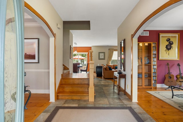4201 Brittany Trail Dr, Champaign, IL 61822 - entrance foyer with arched walkways, stairs, baseboards, wood finished floors, and visible vents