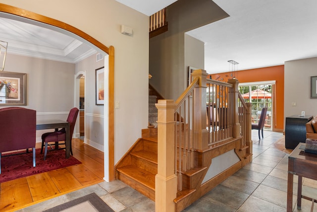4201 Brittany Trail Dr, Champaign, IL 61822 - stairway featuring visible vents, crown molding, arched walkways, baseboards, and tile patterned floors