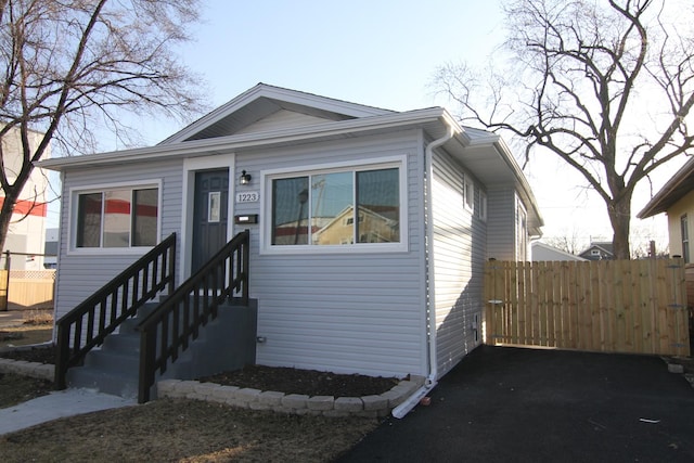 bungalow-style house featuring entry steps and fence