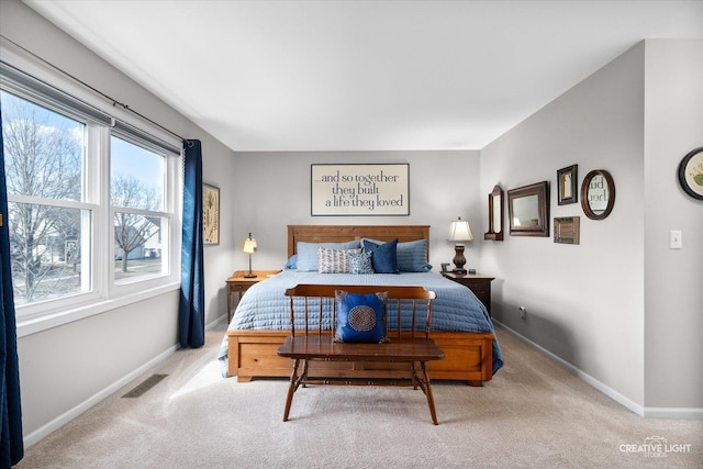 carpeted bedroom featuring visible vents and baseboards