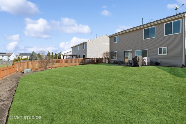 back of property featuring a yard and a fenced backyard