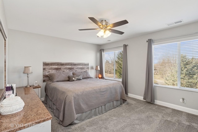 bedroom with carpet flooring, baseboards, visible vents, and ceiling fan