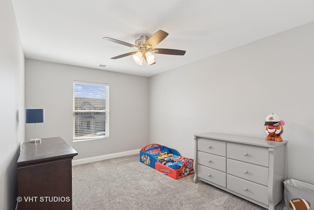 bedroom with carpet flooring, visible vents, baseboards, and ceiling fan