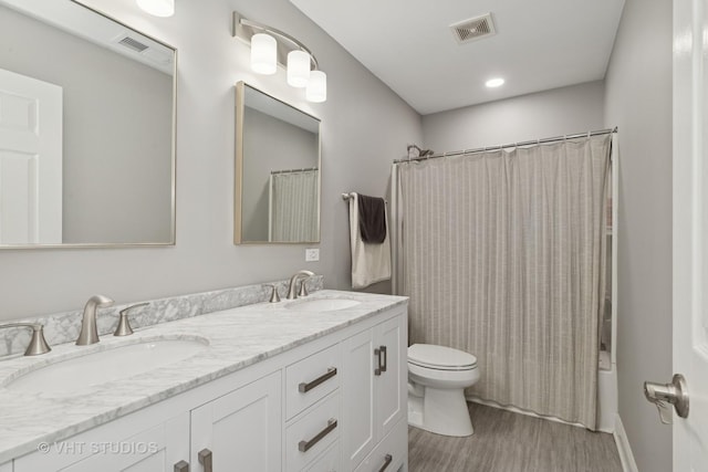 bathroom with visible vents, toilet, and a sink