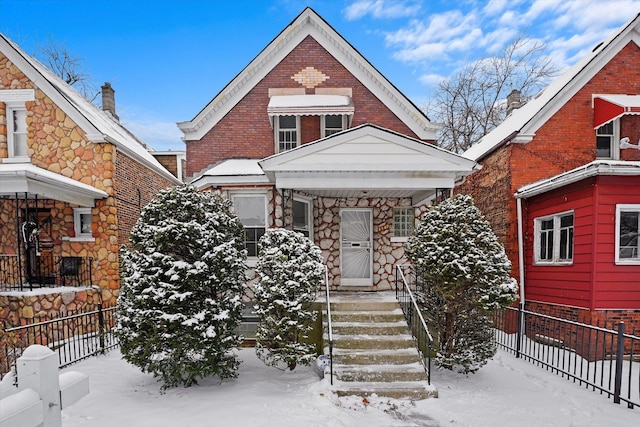 view of front of home with fence and brick siding