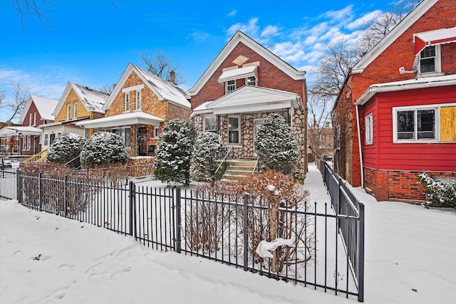 view of front of home featuring brick siding and a fenced front yard