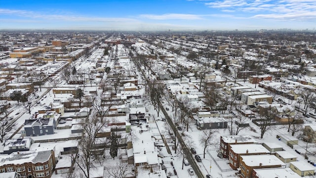 snowy aerial view featuring a residential view