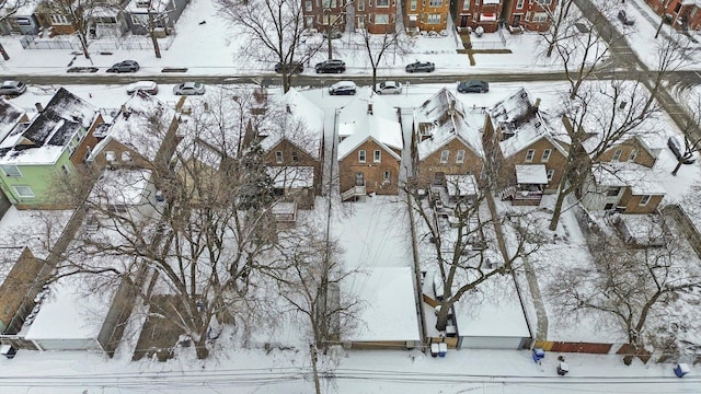 snowy aerial view with a residential view