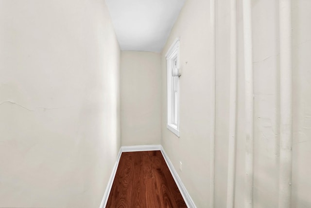 hall with dark wood finished floors and baseboards