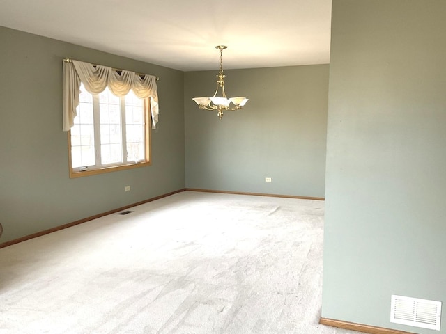 unfurnished room with a notable chandelier, visible vents, baseboards, and carpet floors