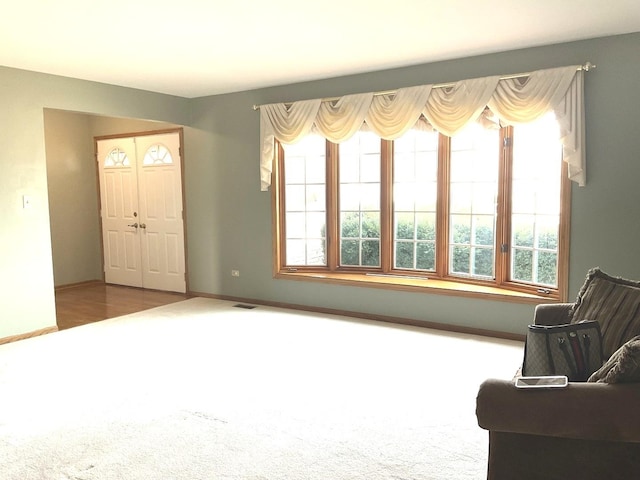 sitting room featuring visible vents, baseboards, and carpet flooring