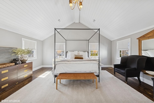 bedroom with lofted ceiling with beams, a notable chandelier, wood finished floors, and baseboards