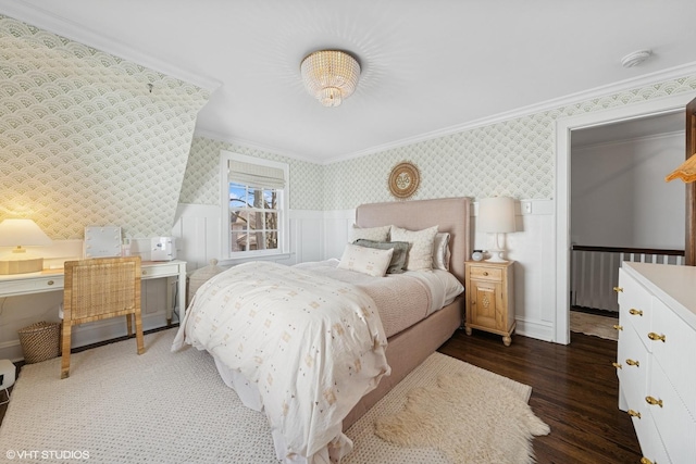 bedroom featuring a wainscoted wall, wood finished floors, crown molding, and wallpapered walls