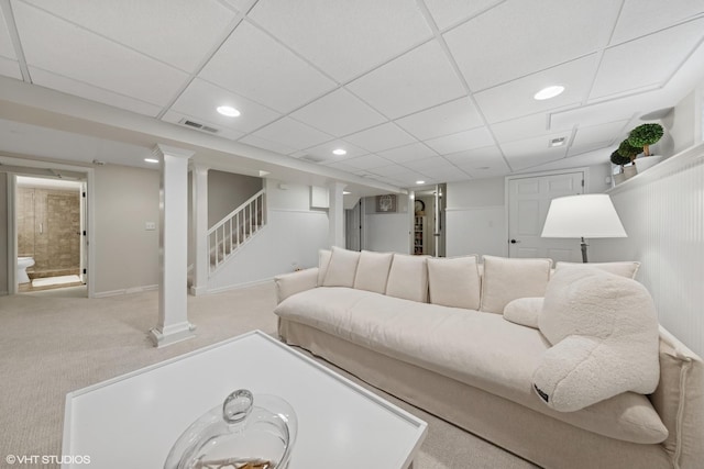 carpeted living area with visible vents, decorative columns, recessed lighting, stairs, and a paneled ceiling