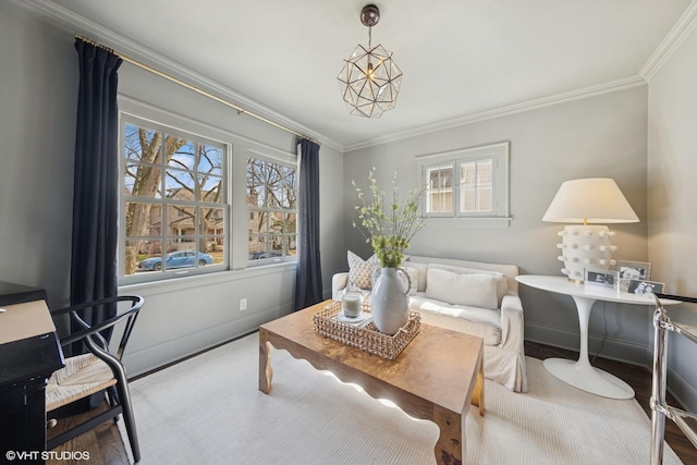 living area with crown molding, baseboards, and wood finished floors