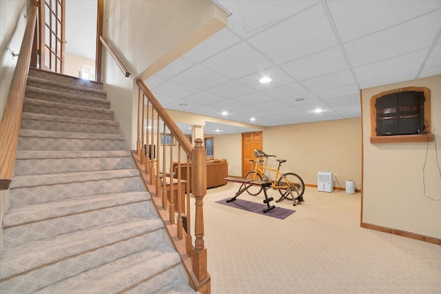 interior space featuring recessed lighting, a drop ceiling, baseboards, and carpet