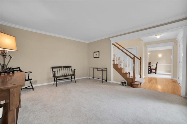 living area featuring stairway, carpet, baseboards, and ornamental molding