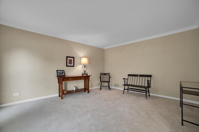 sitting room with baseboards, ornamental molding, and carpet flooring