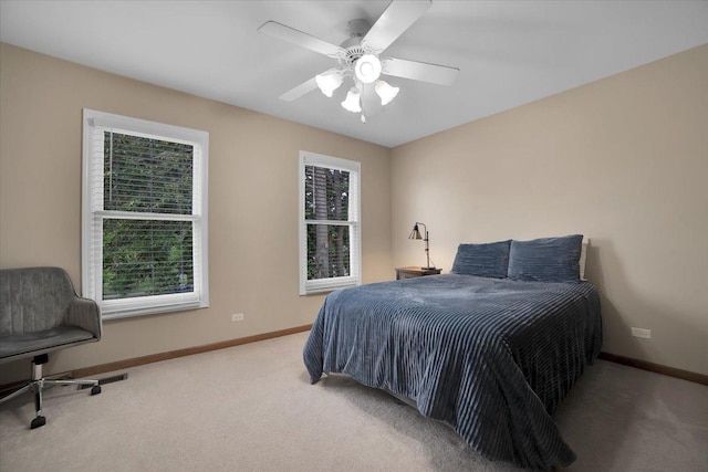 carpeted bedroom featuring a ceiling fan and baseboards