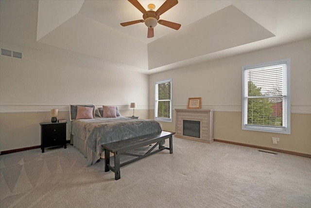 bedroom with visible vents, a tray ceiling, and carpet floors