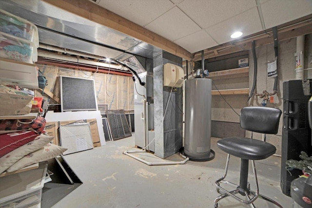 unfinished basement featuring water heater, a drop ceiling, and heating unit