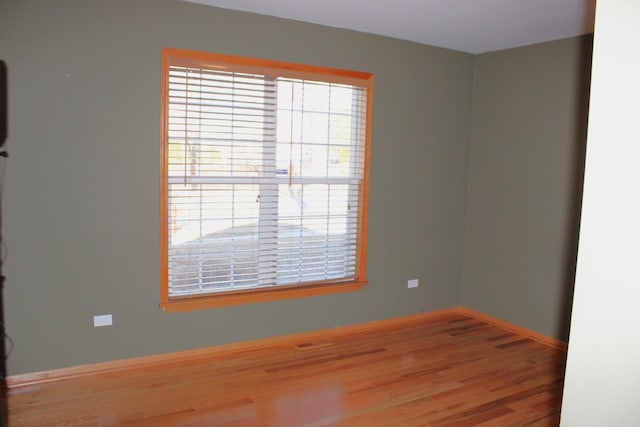 unfurnished room with wood finished floors