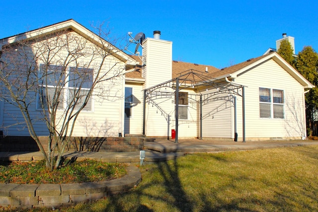 view of front facade featuring a chimney and a front lawn