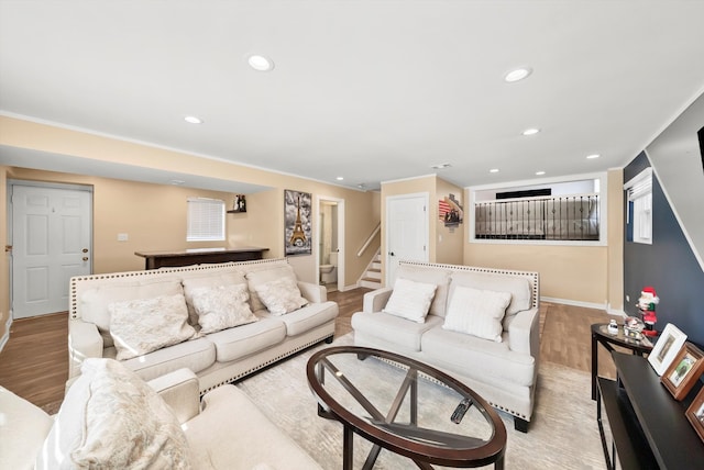 living area featuring recessed lighting, baseboards, stairs, and light wood-style floors