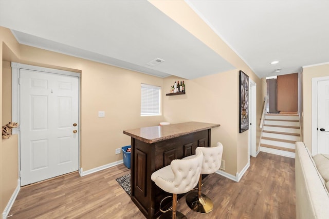 bar with recessed lighting, baseboards, light wood-style flooring, and stairs