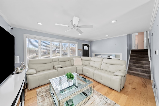 living area featuring recessed lighting, light wood-type flooring, a ceiling fan, and ornamental molding