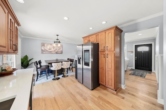 kitchen featuring ornamental molding, stainless steel fridge with ice dispenser, light wood finished floors, baseboards, and a chandelier