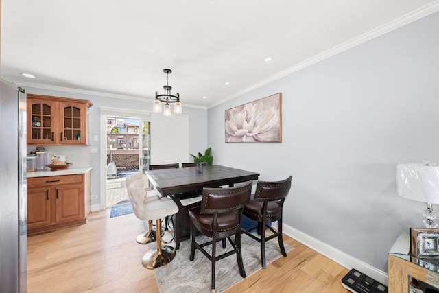 dining room with baseboards, light wood-style flooring, recessed lighting, crown molding, and a chandelier