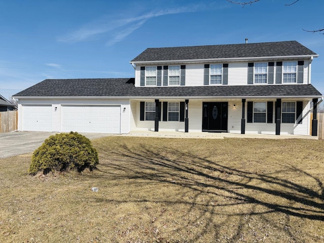 view of front of home featuring a garage, covered porch, driveway, and roof with shingles