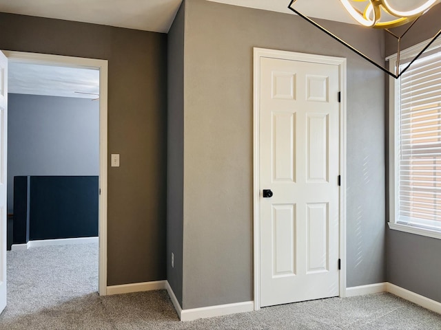 unfurnished bedroom with baseboards and carpet floors